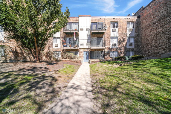 Front view of a multi-story brick apartment building