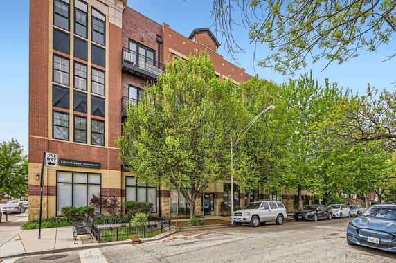 Front view of a multi-story brick building with balconies.