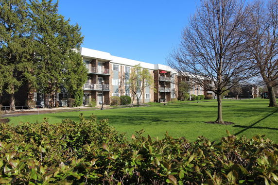 Front view of a multi-story apartment building with balconies.