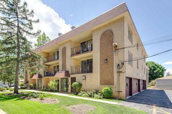 Front view of a multi-story residential building with balconies.