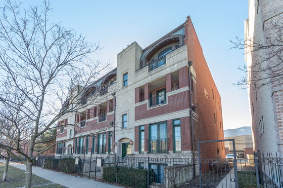 Front view of a multi-story brick apartment building.