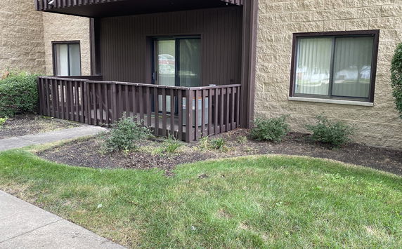 Front view of a building with a small porch and sliding door.