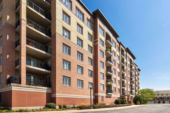 Front view of a multi-story residential building with balconies.