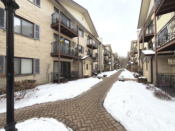 Front view of multi-story apartment buildings with balconies.
