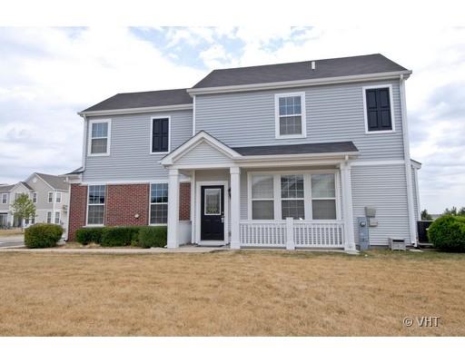 Front view of a two-story house with a porch and mixed siding.