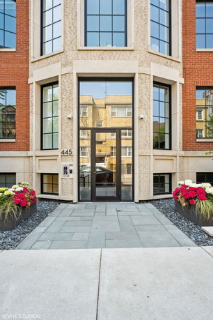 Front view of a modern brick and glass building entrance.