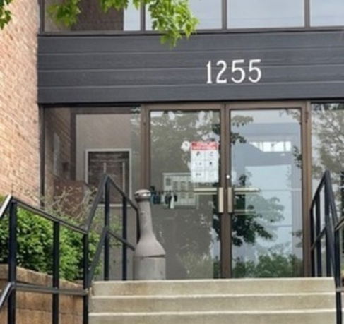 Front entrance of a building with the number 1255 above the doors.