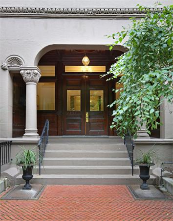 Front view of a building entrance with columns and steps.
