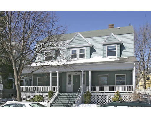 Front view of a two-story house with a covered porch and multiple windows.