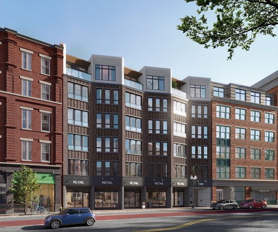 Front view of a multi-story urban building with ground-floor retail space.