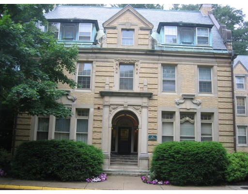 Front view of a multi-story building with ornate architectural details and brick facade.