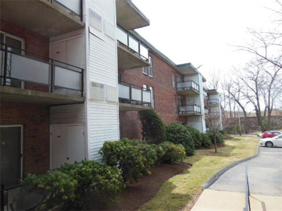 Exterior view of a multi-story apartment building with balconies.