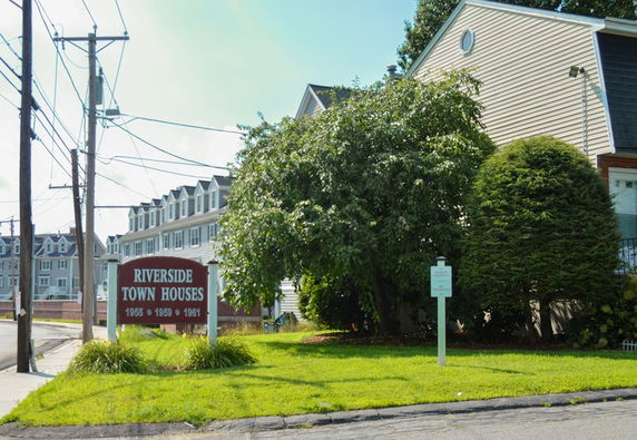 Front view of Riverside townhouses with multiple stories.