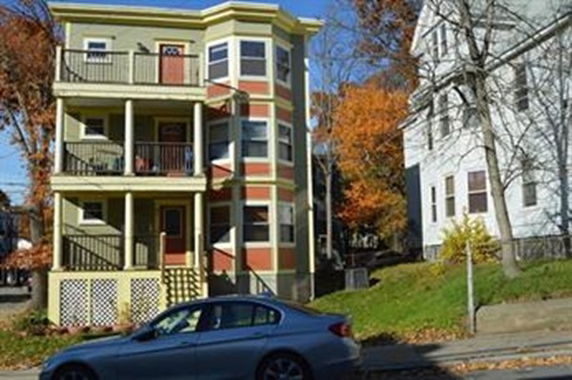 Front view of a three-story residential building with balconies.