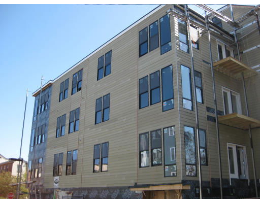 Front view of a multi-story building under construction with numerous windows.
