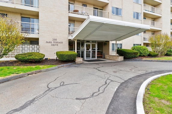 Front view of a multi-story building with a covered entrance.
