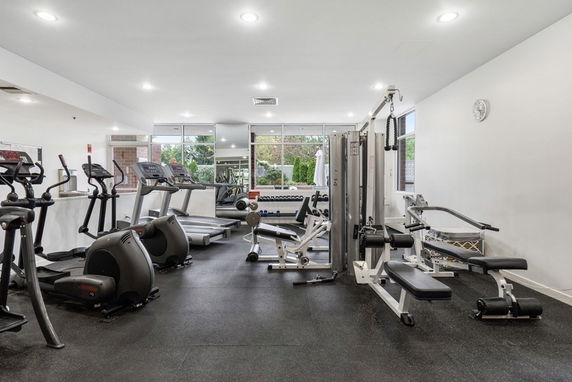 Interior view of a gym with various exercise equipment.