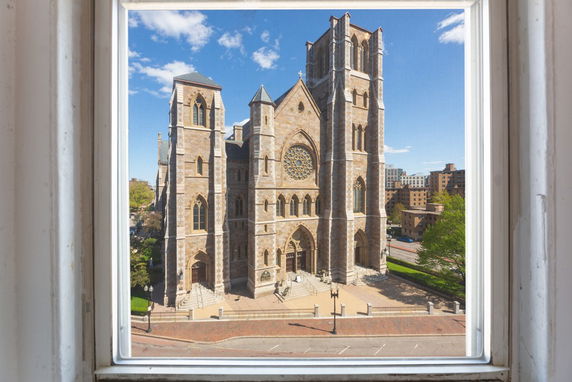 Front view of a large cathedral with intricate architecture and multiple towers.