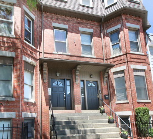 Front view of a two-story brick building with two entrances.
