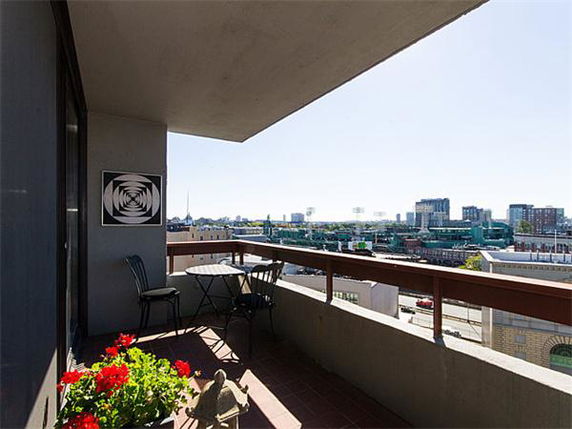 Balcony view overlooking cityscape with visible buildings.