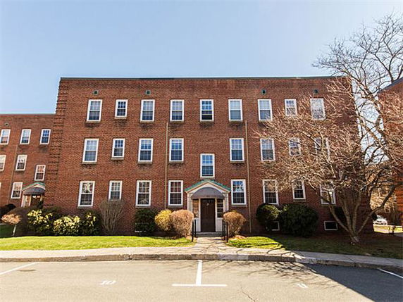 Front view of a three-story brick apartment building