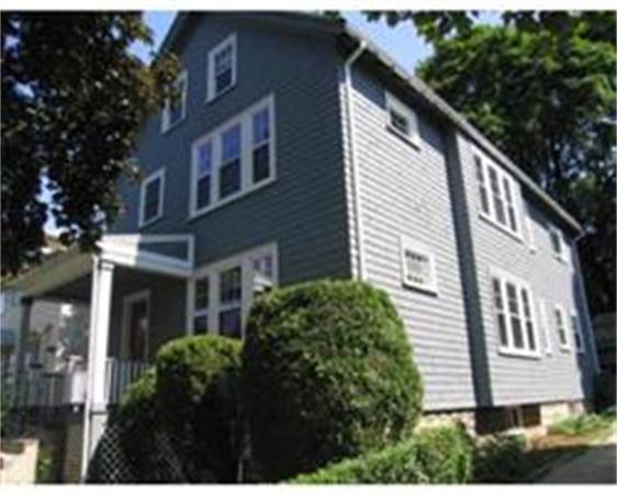 Front view of a two-story house with gray siding.