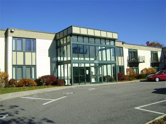 Front view of a two-story commercial building with large glass entrance.