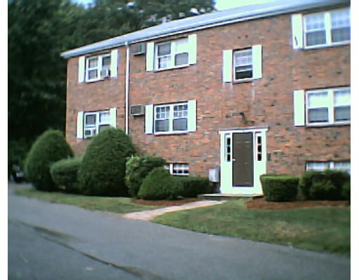 Front view of a two-story brick building with several windows and a main entrance.