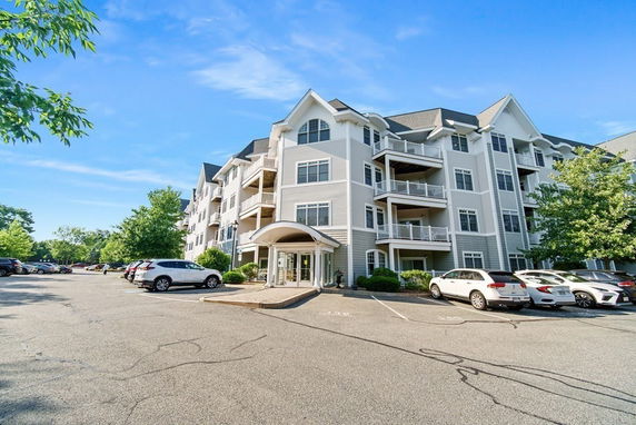 Front view of a multi-story residential building with balconies.