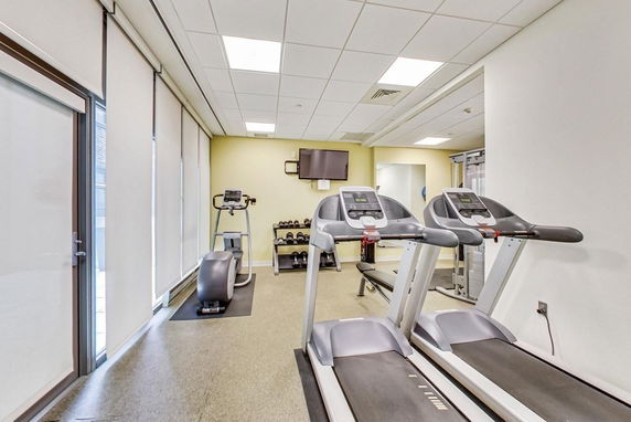 Interior view of a fitness room with treadmills and exercise equipment.