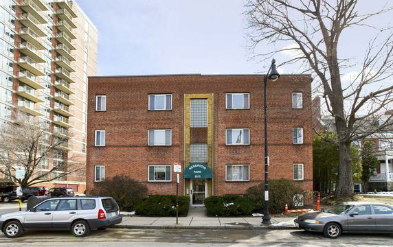 Front view of a three-story brick apartment building.
