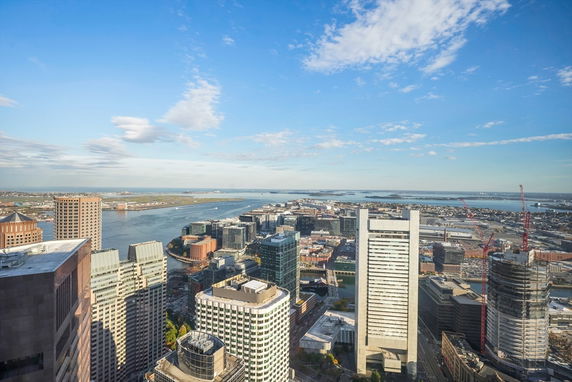 Wide-angle view of a cityscape with skyscrapers and waterfront.