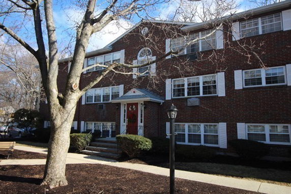 Front view of a three-story brick apartment building.