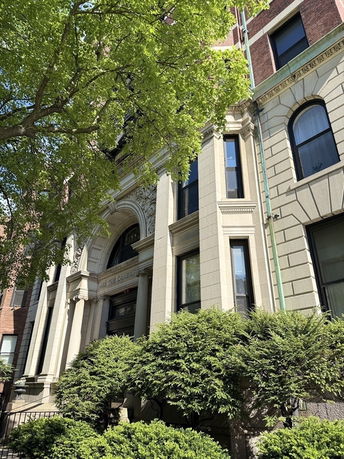 Front view of a classic multi-story building with ornate entryway.