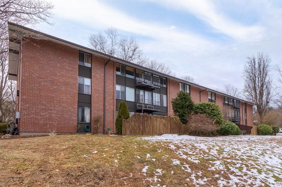 Front view of a multi-story brick apartment building.