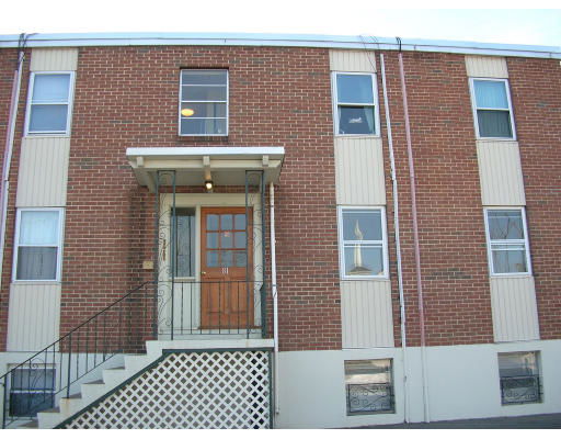 Front view of a two-story brick building with multiple windows.