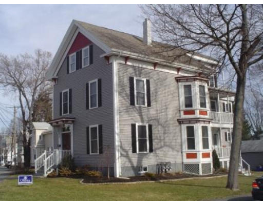 Front view of a two-story house with an attic and porch.