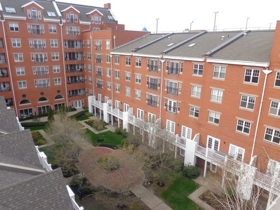 View of a multi-story residential building with brick exterior.