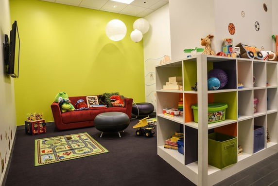 Indoor play area with toys, a small couch, and colorful storage