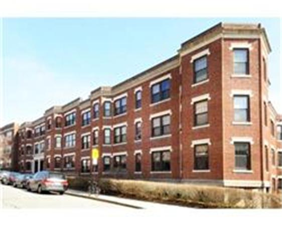 Front view of a multi-story brick apartment building.