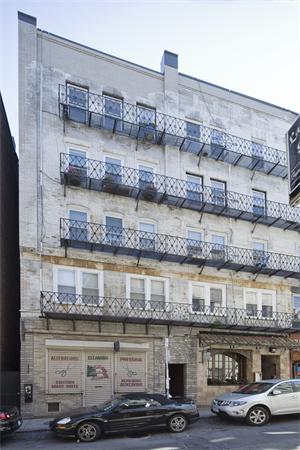 Front view of a multi-story building with balconies.