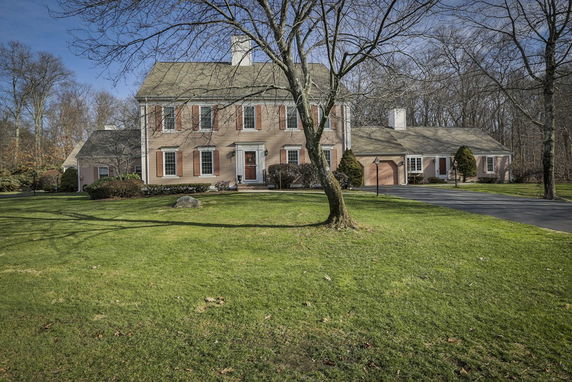 Front view of a large two-story house with attached garage.