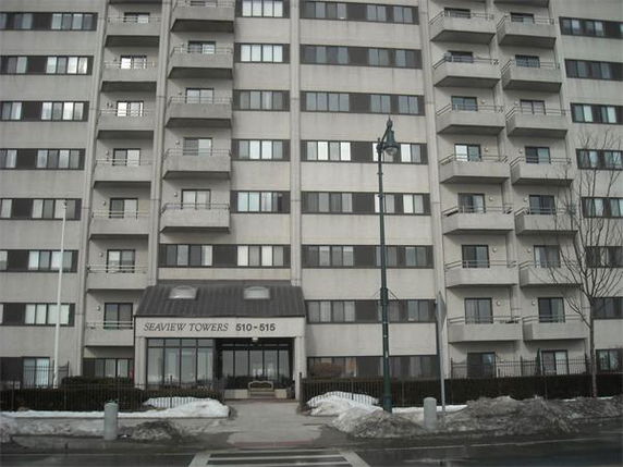 Front view of a multi-story residential building named Seaview Towers with balconies.