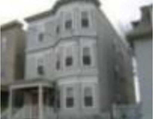 Front view of a three-story house with multiple windows.