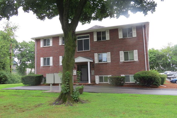 Front view of a three-story brick apartment building.