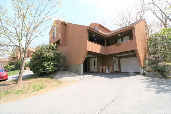 Front view of a multi-story house with a garage.