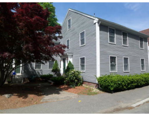 Front view of a two-story house with gray siding and multiple windows.