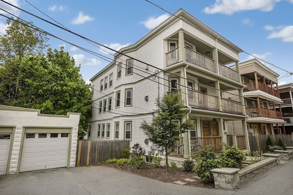 Front view of a three-story residential building with balconies.