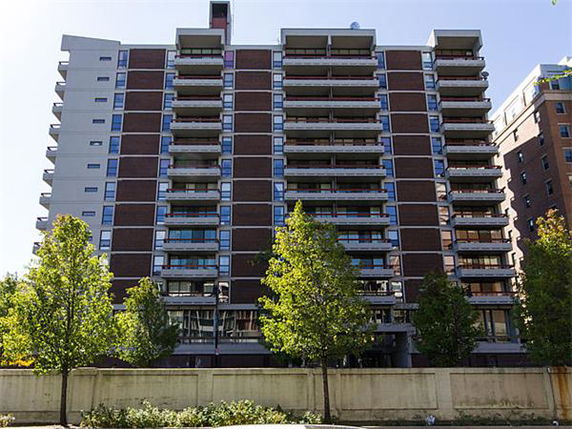 Front view of a high-rise apartment building with multiple balconies.