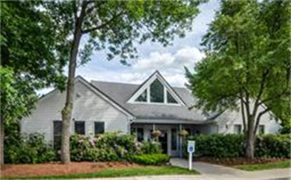 Front view of a single-story house with triangular windows.